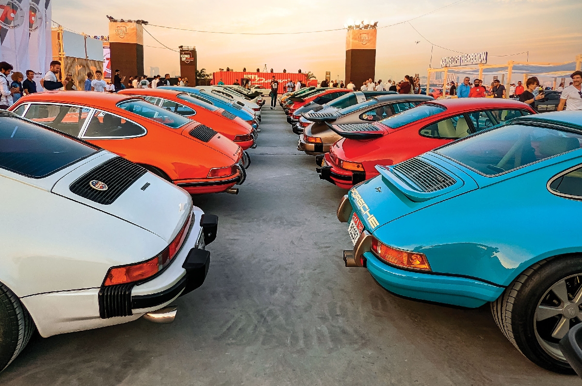 A row of colourful 911s showing off their curvaceous rear. 