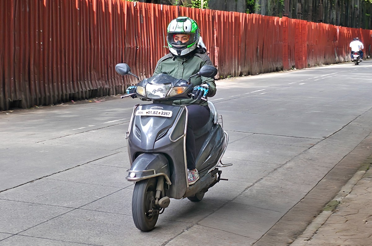 Lady riding Honda Activa in India