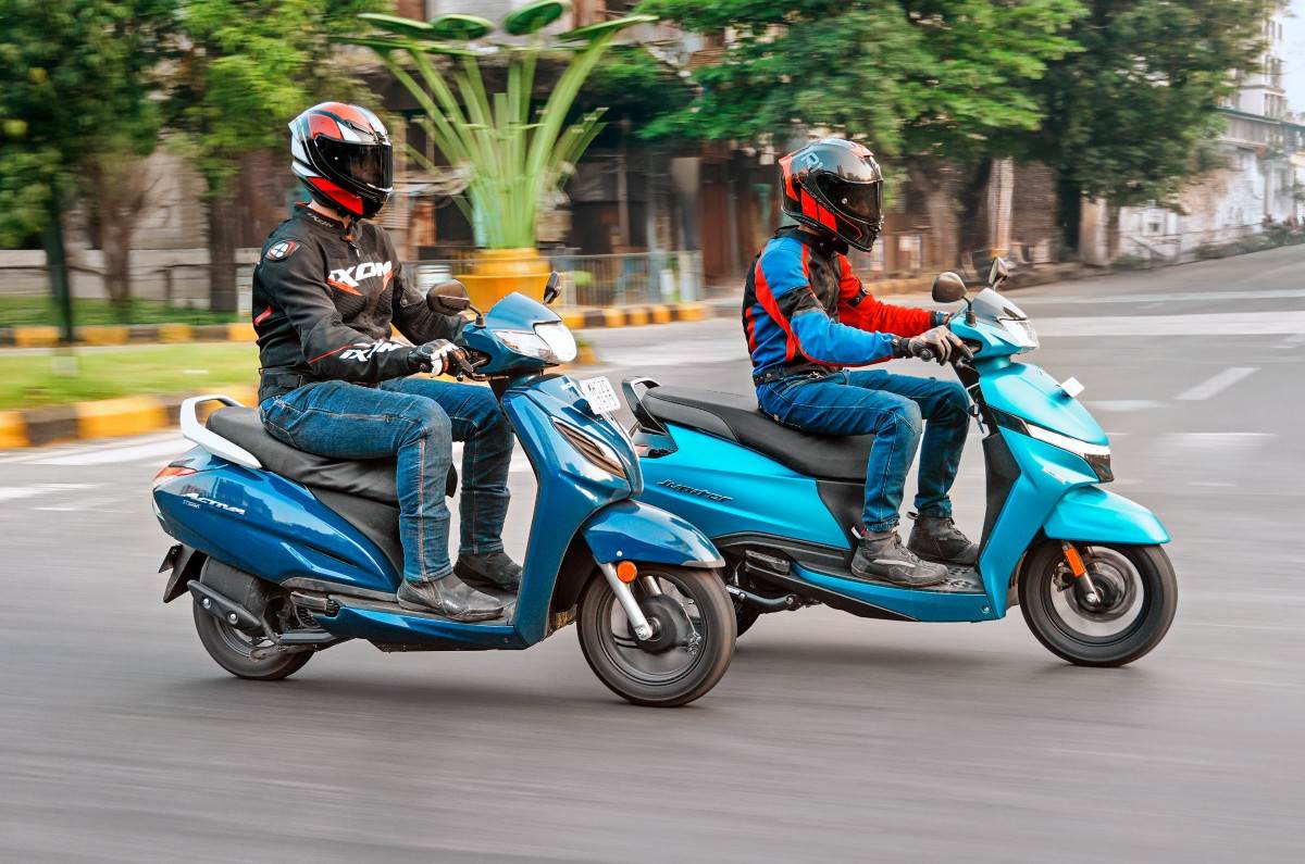 Honda Activa and TVS Jupiter right side front three quarter riding shot on road