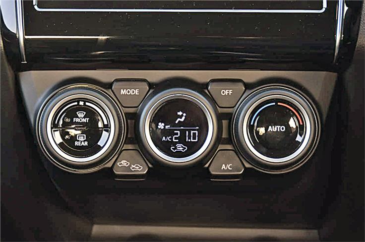 Climate control knobs differ from those on the Dzire. Centre dial comes with inset LED display. 