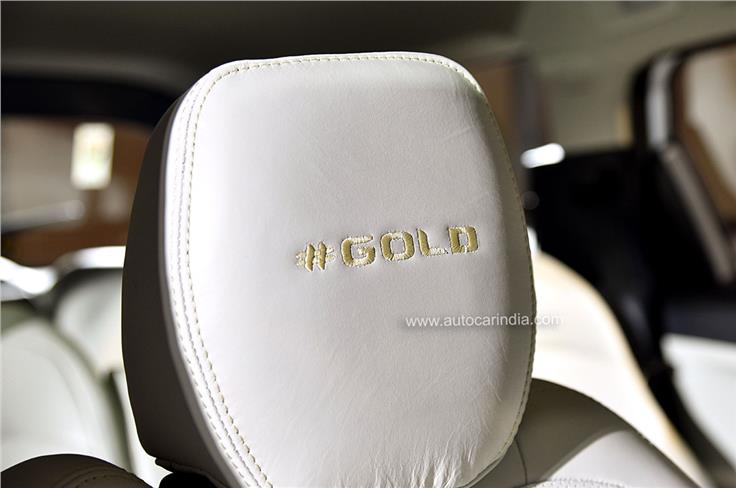 Seats feature '#Gold' stitched into the headrests.