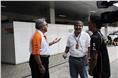 Vijay Mallya and Vicky Chandhok share a light moment in the paddock.