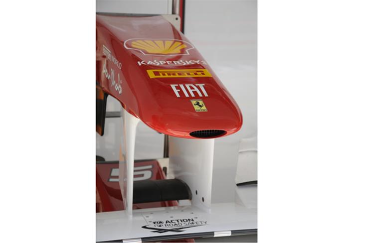 The nose section of Fernando Alonso&#8217;s Ferrari rests in the pit garage.