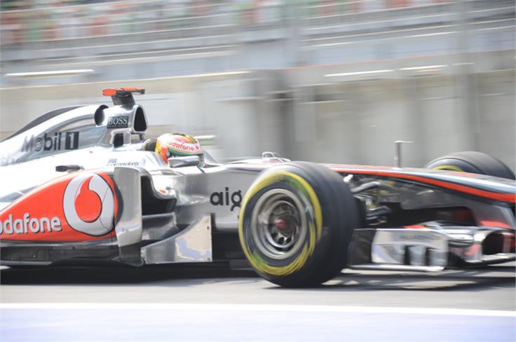 Lewis Hamilton goes down the pitlane in his McLaren.