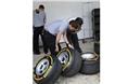 A Pirelli engineer inspects the soft tyres after the free practice session.