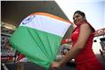 Grid girls hold the Indian flag.