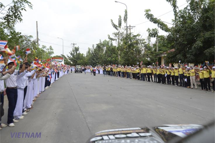 School children lined the streets to welcome the cars into Vietnam