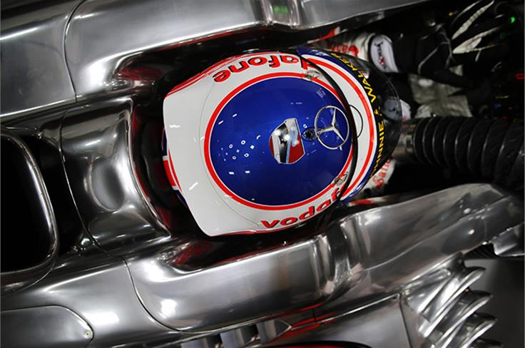 Jenson Button's helmet features a tribute to Porsche racer Sean Edwards, who died in a car crash two weeks ago.