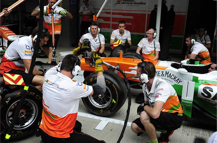 Force India mechanics practice pit stops.