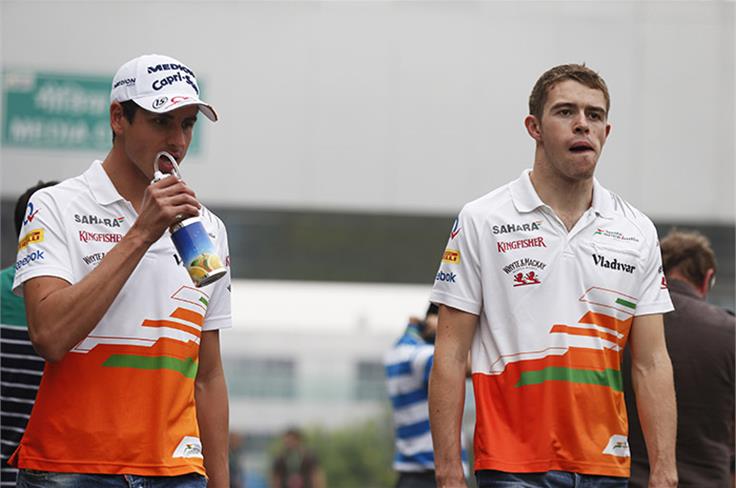 Force India drivers Adrian Sutil and Paul Di Resta in the paddock.