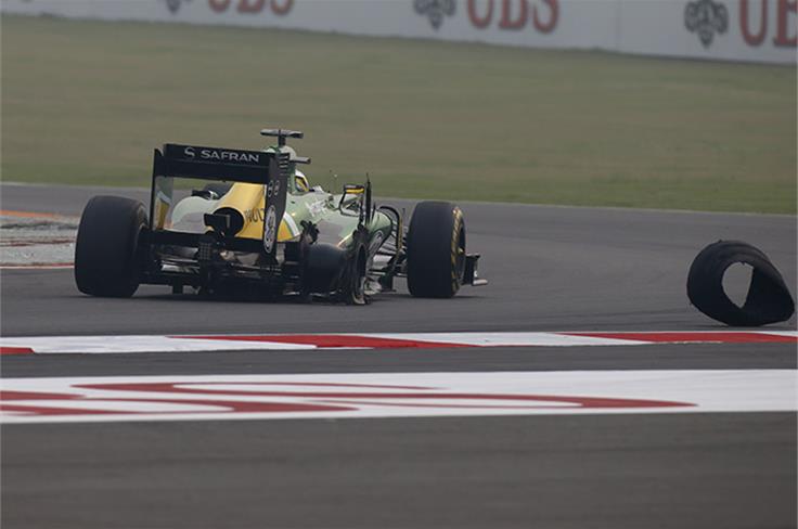 Charles Pic's Caterham loses a rear tyre after a puncture due to contact.
