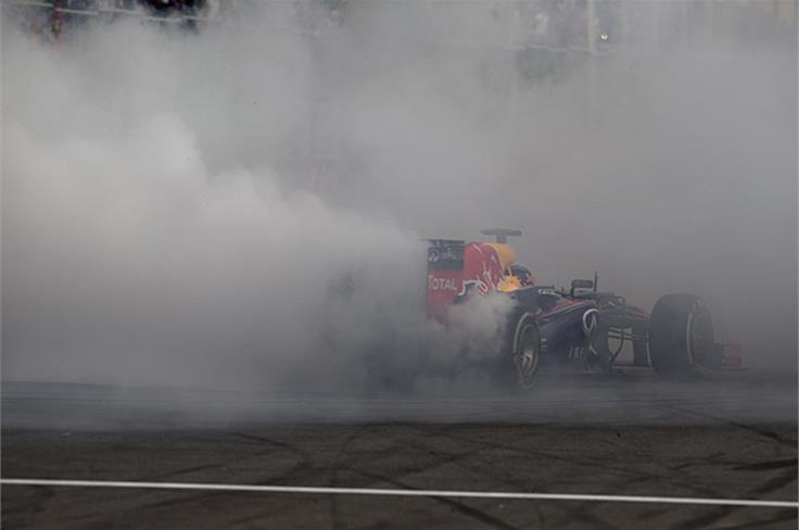 Vettel performs donuts after crossing the line to take his fourth world title.