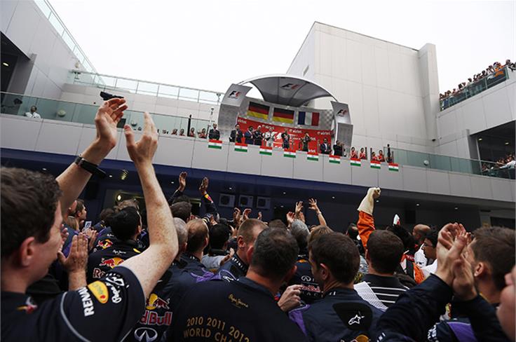 Red Bull team cheering under the podium.