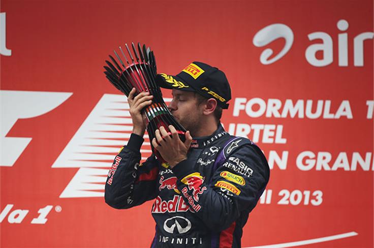 Vettel kisses the Indian GP trophy.