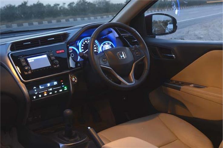 The instrument cluster consists of three round dials. Steering-mounted controls are also on offer in the Honda City.