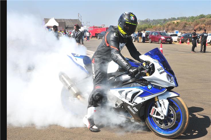 A participant burns rubber before the final run to warm up the rear tyre and lay down power cleanly.