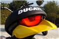 Distinct half-moon taillight with Ducati branding on seat.