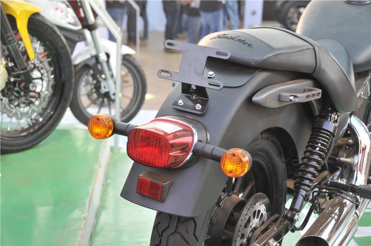 Conventional looking taillight and orange indicators are mounted on an all matt black longish mud-guard. 