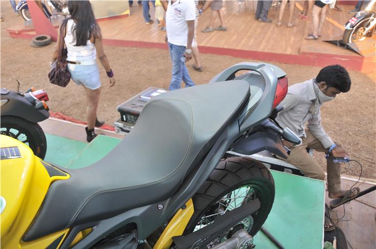 Stepped single saddle with white stitching is seen here. Minimal tank guard also provided. Underseat silencer is also part of the package. 