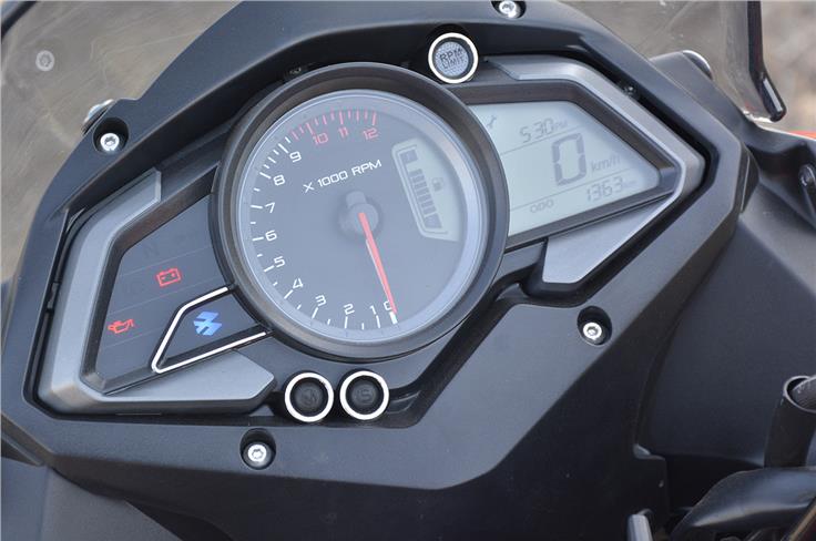 The Bajaj Pulsar AS 150 gets digi-analogue instruments, a useful side-stand engaged sign, clock and a shift-warning light.