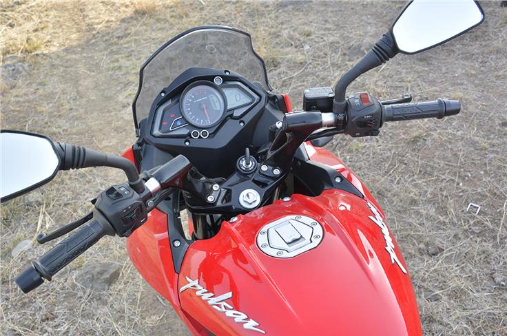 The Bajaj gets bar-mounted mirrors and a hinged fuel-cap.