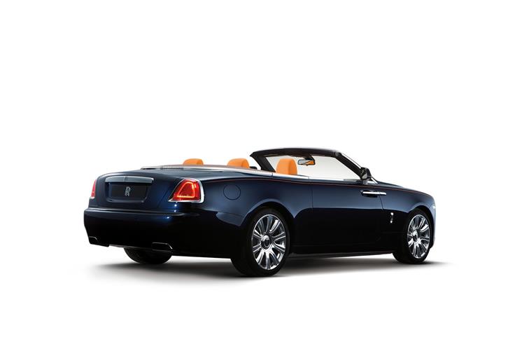 Rolls Royce Dawn rear three-quarters view with the top down.