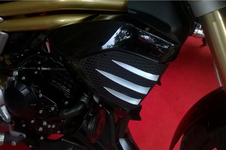 The side cowls over the radiator get scoops to deflect air away from the riders feet & engine.