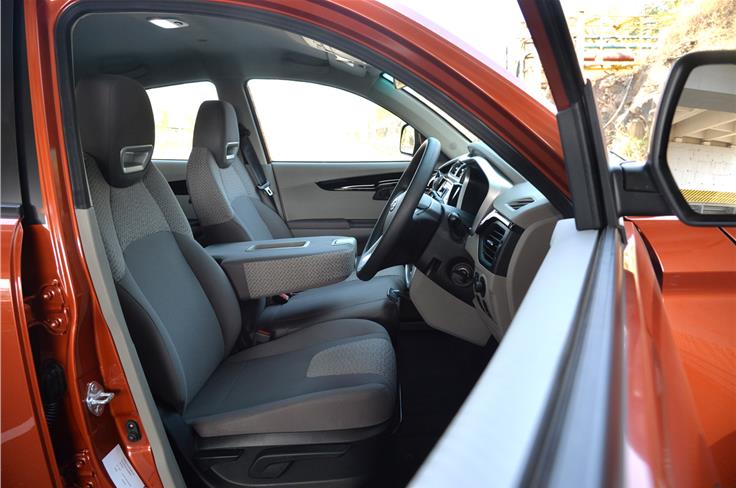 In the six-seat version KUV100, the centre seat's backrest folds down to become a large centre arm rest.
