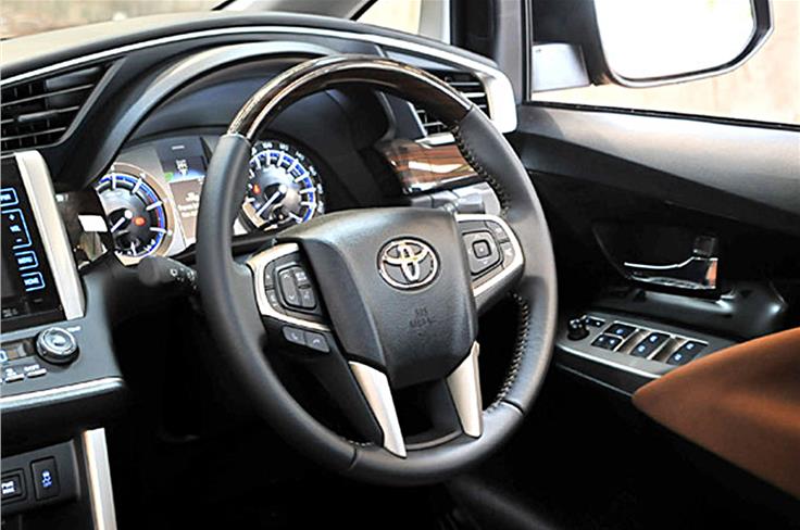 Chunky steering has lots of buttons and is clad in leather and wood. The range of adjustment, however, is very limited.