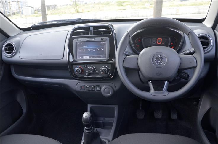 The Kwid&#8217;s dash is dominated by the large touchscreen infotainment system though the dull colours are a let-down. It also has more usable storage spaces than the Redigo.