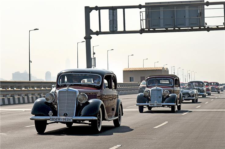 Mercedes-Benz 170Vs, 190SL and a long line of pristine classics drive down the sea link.