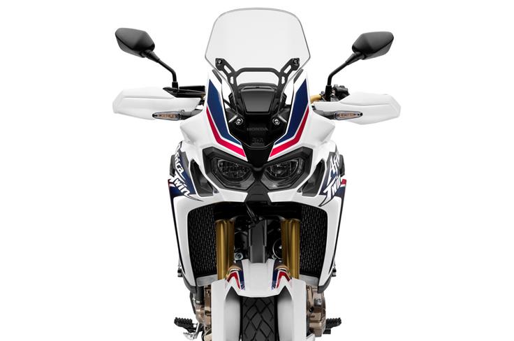 The Africa Twin is immediately recognizable with its dual headlights and upright front fairing.