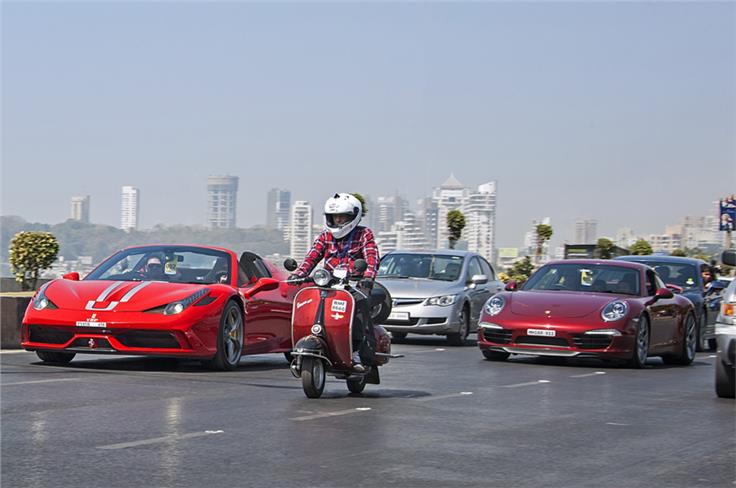 Yohan Poonawalla&#8217;s Ferrari 458 Speciale Aperta seen alongside a vintage Vespa and a Porsche 911.