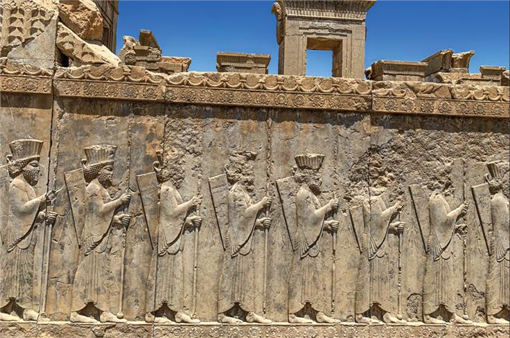 Intricate stone carvings of soldiers at Persepolis.