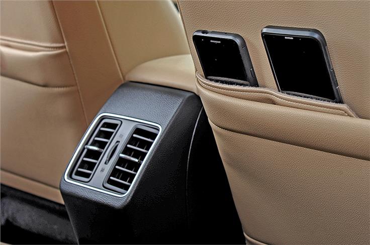 Rear AC vents aid cooling and seatbacks have unique phone storage space.
