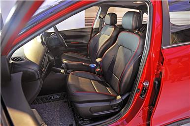 The i20 Turbo model gets a black interior with red accents on the seats and the cabin.