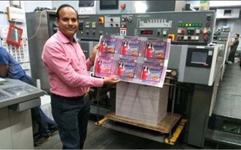 Prashant Manoj Patel of Pradipam Offset with a print sample