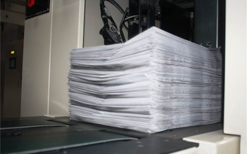 A bundle of printed newspaper being collected by the Seiken mailroom system