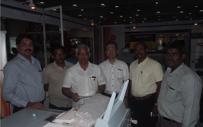 One of the busiest stalls in this year's event were the debutants ePrint Machinery, who along with their principals from Horizon did good business and were seen happily interacting with one and all from the industry. O Venugopal of Anaswara Offset seen posing with ePrint and Horizon team. The company also launched their cutting system eCut at the show