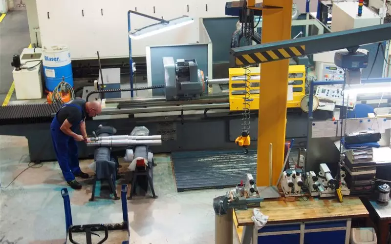 A lathe machine where a steel shaft is being produced