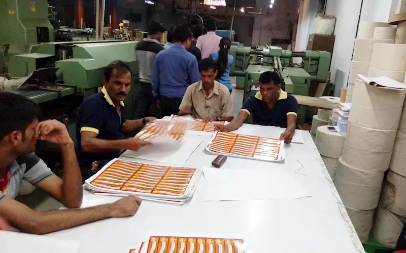 Employees inspecting individual sheets