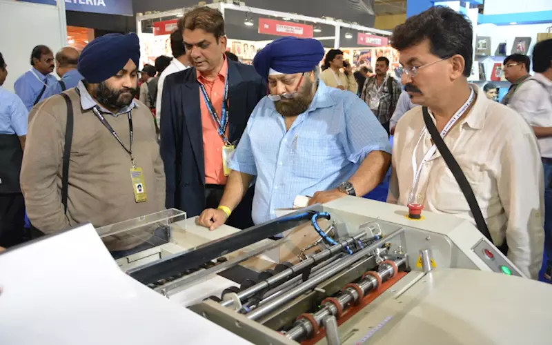 Parag Shah of Hi-Tech giving demo to the customers. Hi-Tech Systems had showcased the Digi Binder and Photofast machine at the stall