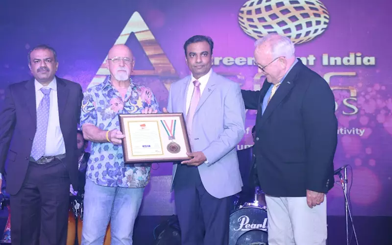 (From left): Devang Sheth, managing director at Aditya Expositions, Charlie Taublieb, Bhargav Mistry, managing director at Grafica Flextronica receiving the award along with Mike Young