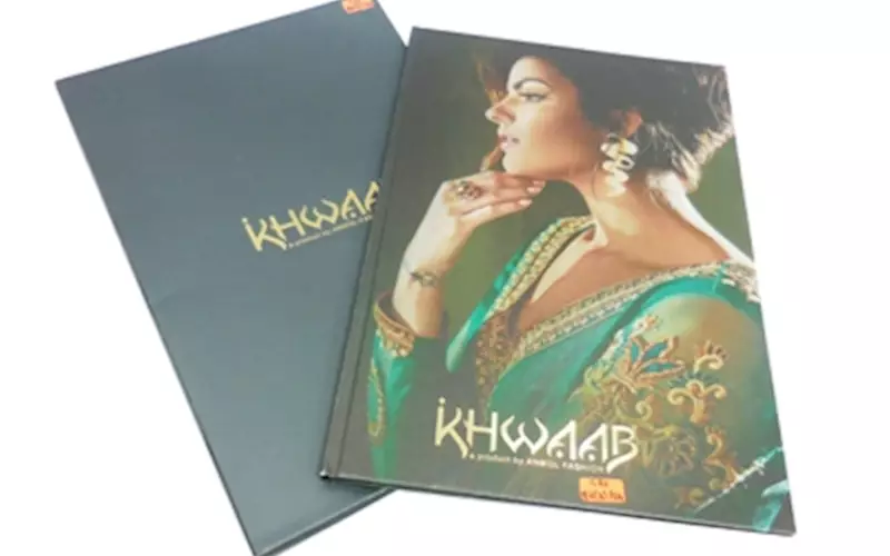 ALMATS BRANDING SOLUTION | Khwaab Aura Collection BookLength of run: 600Art: Text pages: CMYK and slipcase with Pantone 547CPre-Press: GMG Process systemPress: Ryobi 920 and SordzPost-Press: Aqueous coating on all pages plus gold foil stamping on slipcasePaper: Cover: 120gsm Stardream Diamond paper, text: 130gsm Ensemble pure white paper, slipcase: 350gsm white back duplex boardSpecial feature:  Gold sticker pasting on the hardcase cover and punching and pasting on slipcase