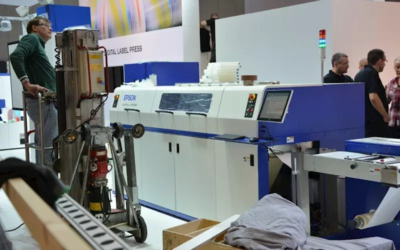 Epson SurePress 4033AW is part of the many industrial label presses the company is show casing. Also see, GM&#8217;s laser cutting machine running next to the SurePress