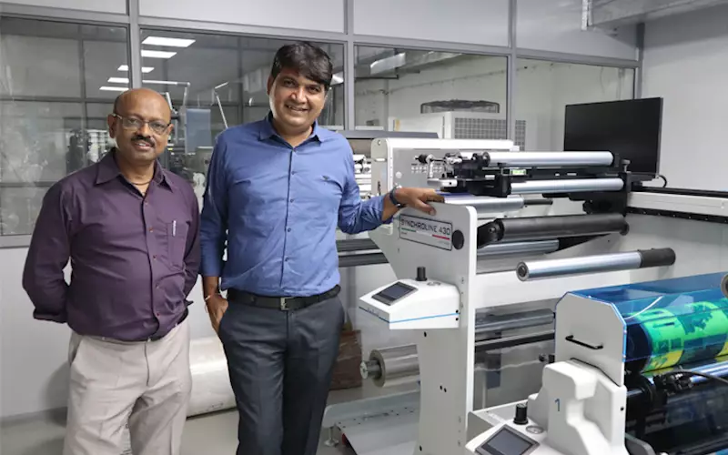 (l-r) Manish and Minesh Patel of Shreedhar Labels with Lombardi Synchroline narrow-web printing press