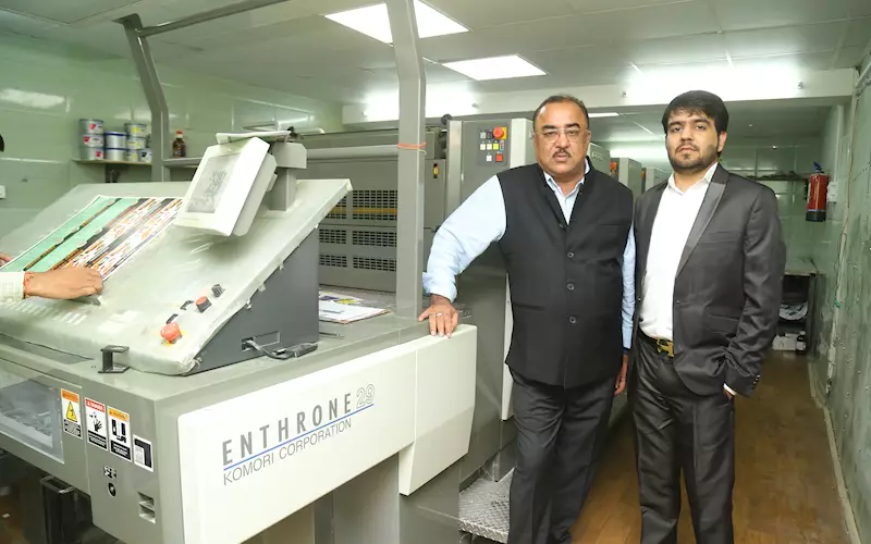 Khushi Ram Dhanwani, the owner of Darpan Printers, and his son, Aaryan, with the new Komori
