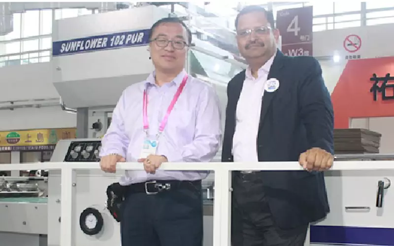 (l-r) Donal Ng of Shanghai Yoco Printing Machinery with its Indian representative Rajesh Agarwal of SRK Technology. Yoco has global partnership with Nikko, Mabeg Machinery Shanghai, Tanabe, Steinmann, Vega, Yawa and Kohmann. The company had 10 products on display, including flute lamination, PUR lamination machine, cold lamination machine, window patching machine, double side taping machine for stripping, and others