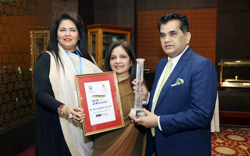 (l-r) Monica Malhotra Kandhari, managing director, and Satish Bala Malhotra, chairperson, MBD Group, receive the award from Amitabh Kant, CEO, Niti Aayog
