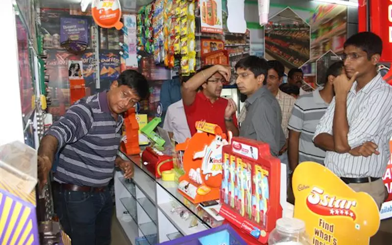 Amit Shah demonstrates how the products would look on the shelf in a kirana shop